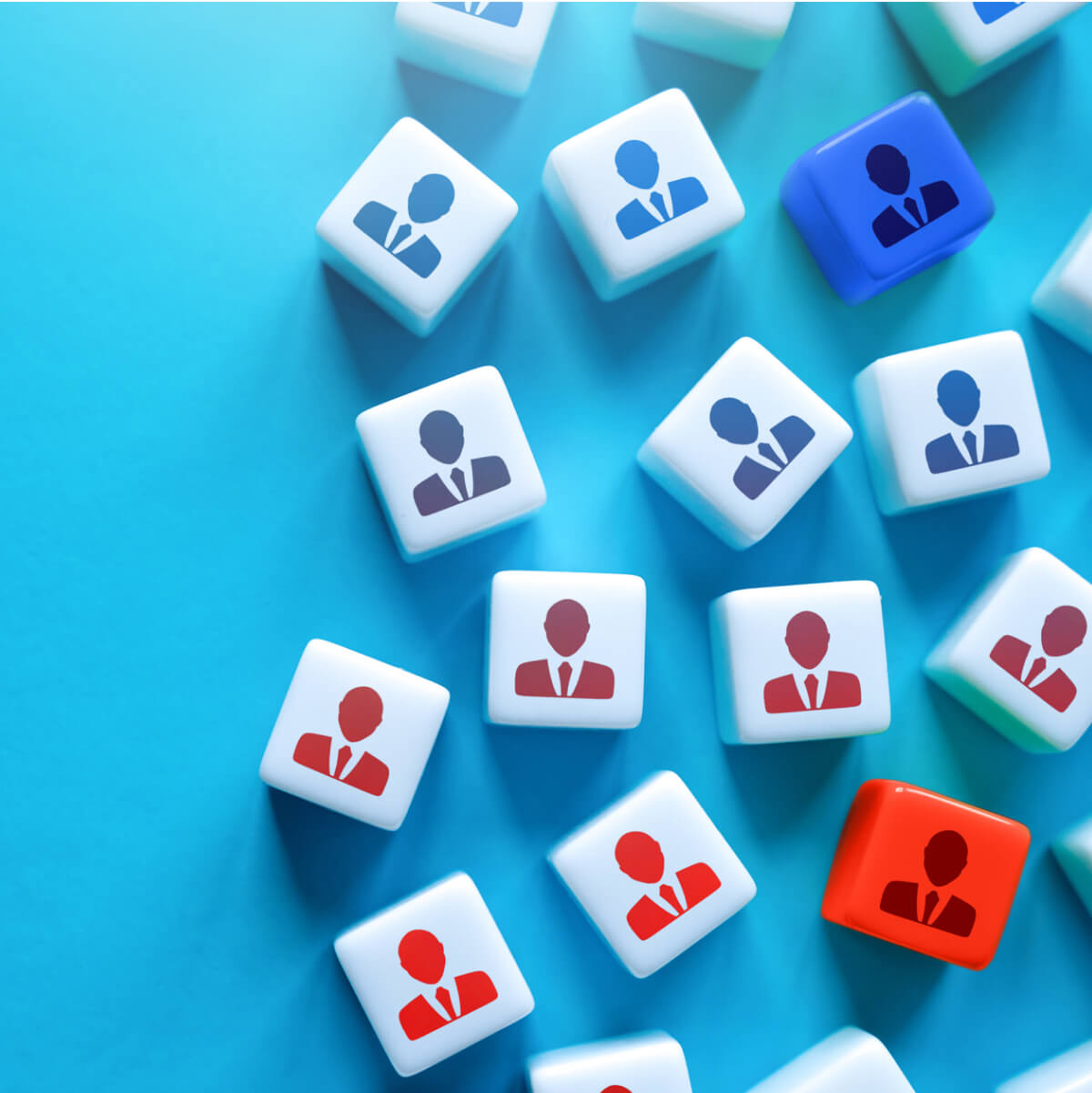 Dice with outlines of people on them, some in red and some in blue.