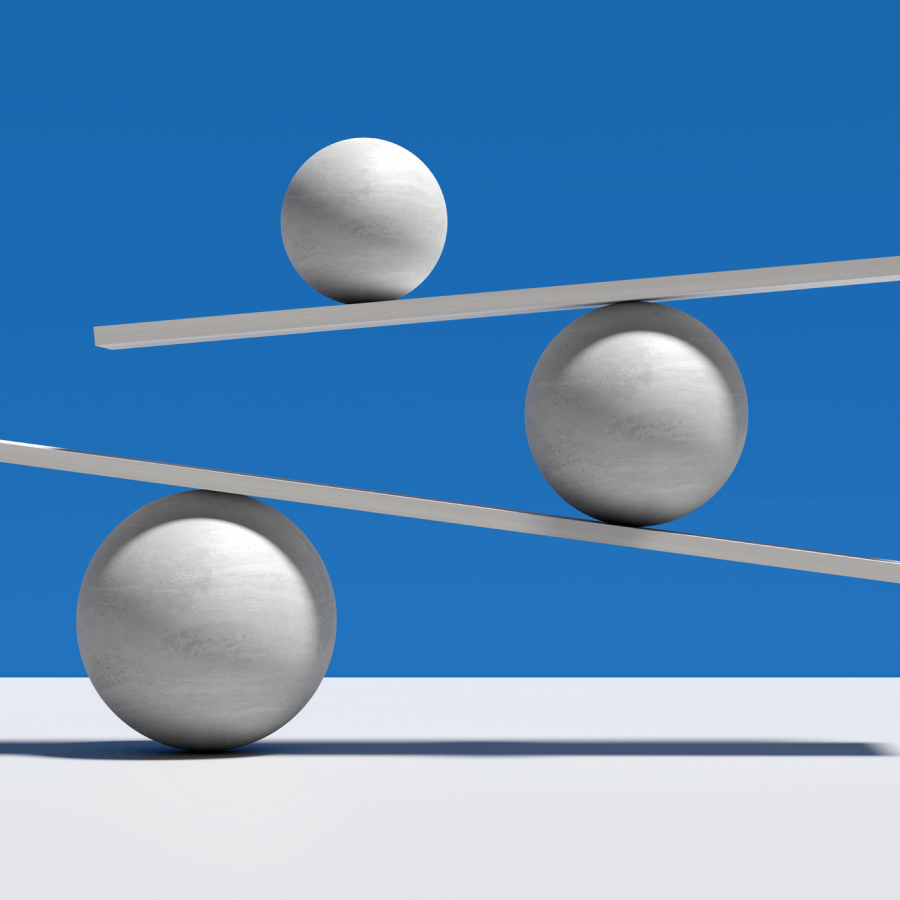 Three balls balancing on wood planks.